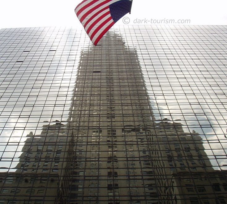 reflection of the Chrysler Building with flag