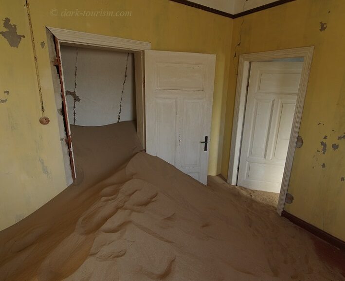 doors 10 - sand encroaching on the interiors and doors at Kolmanskop