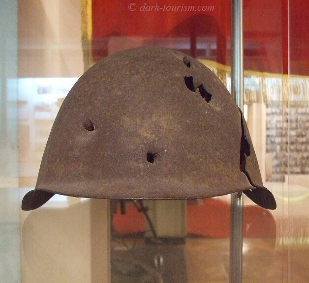 bullet holes 06 - helmet with multiple bullet holes on display in the war museum in Gori, Georgia